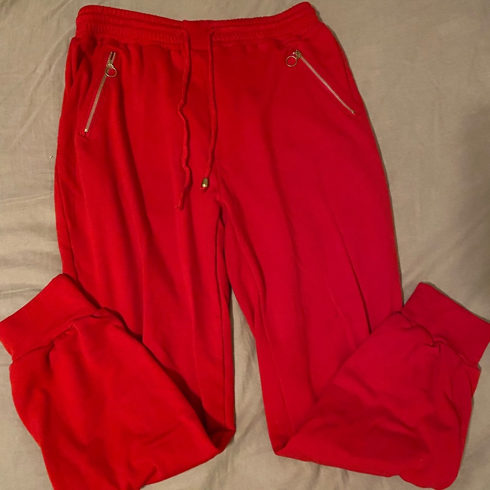 red sweat pants with gold zipper for pockets